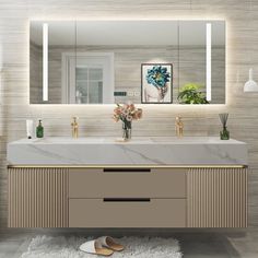 a bathroom vanity with two sinks and mirrors