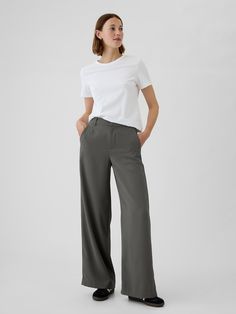 Soft woven trousers.  E-waist with concealed hook and bar closure, zip fly.  Front slant pockets, back welt pockets.  Flat front.  * Fit: Classic.  An easy silhouette that fits close  at the waist, and is relaxed through the hips and thigh.  Models wearing Gap Women’s Work Trousers, High Rise Trousers, Capsule Wardrobe Basics, Easy Silhouette, Red Trousers, Work Trousers, Grey Trousers, Wardrobe Basics, Grey Pants