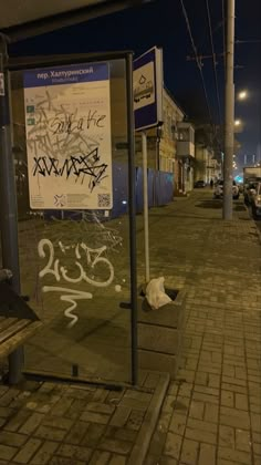 a bus stop with graffiti written on it