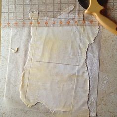 a pair of scissors sitting on top of a piece of paper next to a ruler