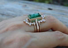 A Jaw-Dropping 3 Piece Bridal Ring Set features a Shimmery Large Lab-made 5ct Emerald/Rectangle Cut Emerald Faceted Engagement Ring paired with 2 Contour Wedding Bands handcrafted in 14k Solid Rose/Yellow/White Gold is simply divine! Our Lab-Made Emerald Engagement Ring Set will have her swooned as it is a very unique ring set. It comes with a Ring Box ready for gift-giving.(r-set-101) Engagement Ring Info ---------------------- Solid 14k Rose /Yellow/White Gold Lab Made Green Emerald 5ct Emeral Wedding Bands For Rectangle Rings, Green Emerald Engagement Ring With Band, Large Emerald Engagement Ring, Gold Emerald And Diamond Engagement Ring, Unique Emerald Wedding Rings, Rectangle Emerald Ring, Emerald Ring Set, Luxury Emerald Cut Stackable Wedding Rings, Wedding Jewelry With Three Stone Baguette Cut