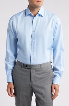 A solid hue brings versatility to a handsome dress shirt made from convenient non-iron cotton oxford cloth in a traditional fit. 33 1/2" length; 53" chest length (size 18) French placket Spread collar Rounded, adjustable button cuffs 100% cotton Machine wash, tumble dry Imported Formal Light Blue Tops With Button Cuffs, Light Blue Formal Tops With Button Cuffs, Light Blue Formal Top With Button Cuffs, Semi-formal Blue Shirt With Placket, Blue Button-up Dress Shirt For Daywear, Light Blue Fitted Shirt For Daywear, Fitted Light Blue Shirt For Daywear, Light Blue Formal Shirt With Button Cuffs, Light Blue Formal Shirt With Buttons