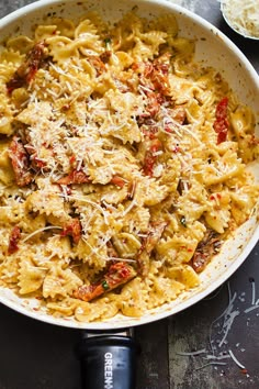 a large white bowl filled with pasta and sauce