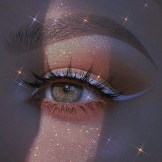 a woman's eye with glitter on it