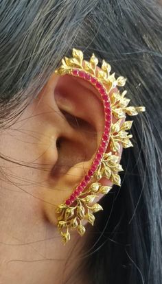 The ethnic ear cuff is made from brass material and crystals and is finished in an attractive antique  gold color. Furthermore, this product features a cuff shape, it hugs the ear as if it's part of it and makes it looks very attractive and comfortable to wear.  It is a design that renders it with the versatility to be worn as a festive occasion wear looks elegant with a gown also! Gold Metal Ear Cuff For Wedding, Gold Brass Ear Cuff For Parties, Bohemian Gold Brass Ear Cuff, Gold Bohemian Ear Cuff For Party, Gold Clip-on Ear Cuff For Wedding, Ear Cuffs Gold Indian, Ear Cuffs Gold, Palm Bracelet, Indian Accessories