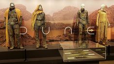 there are three mannequins that are on display in front of a desert scene