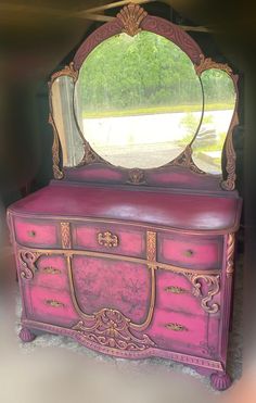 a pink dresser with a mirror on top