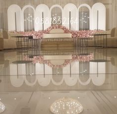 a large room with chairs, tables and flowers on the floor in front of it