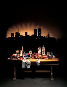 a table with many boxes on it in front of a cityscape at night