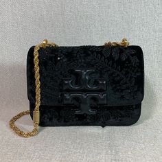 Price Is Firm Velvet Eleanor Small Convertible Shoulder Bag/Cross Body Bag By Tory Burch. This Bag Is Made Of Black Embroidered Velvet. This Bag Is Convertible. Can Be Carried As A Shoulder Bag Or Cross Body Bag. Dimensions: 7.5" Wide Across Bottom X 5" Tall Center X 2.5" Deep. Strap Drop Doubled 11.5", Single 22". Interior: 3 Compartments. 1 Zipper Compartment Flap Closure Secured With Magnetic Button. Leather Interior. Gold Tone Metalware. Comes With Dust Bag !!! Elegant Bags With Embroidered Logo For Everyday Use, Evening Bags With Embroidered Logo, Black Leather Shoulder Bag With Embroidered Logo, Luxury Embroidered Logo Crossbody Bag, Elegant Rectangular Bag With Embroidered Logo, Designer Embroidered Rectangular Bag, Black Leather Bag With Embroidered Logo, Luxury Embroidered Clutch Shoulder Bag, Black Embroidered Formal Bag