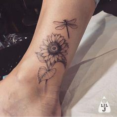 a sunflower with a dragonfly tattoo on the foot