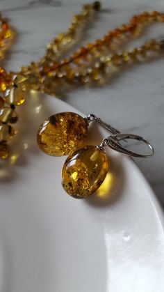 ❤ These beautiful drop earrings are made of genuine lemon or light green amber with 925 sterling silver details.  ❤ Such jewelry is always a perfect gift for every woman and for any occasion. Especially amber stones add luxury and romance to the whole style & make it look more exclusive, because every amber stone is unique. There are 3 different earrings: 1) light green - photos 1-4; diameters 1.7 x 1.4 cm (0.67 x0.55 inches) 2) lemon 1 - photos 5-7; diameters 1.5 x 1.3 cm (0.59 x 0.51 inches) 3 Amber Citrine Earrings With Ear Wire, Amber Sterling Silver Hypoallergenic Earrings, Hypoallergenic Amber Sterling Silver Earrings, Hypoallergenic Sterling Silver Amber Earrings, Amber Dangle Earrings With Lever Back, Amber Citrine Drop Earrings, Amber Citrine Teardrop Earrings, Handmade Amber Earrings For Anniversary, Yellow Baltic Amber Jewelry For Gifts