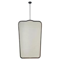 a light hanging from a ceiling fixture with a white shade on the bottom and black trim