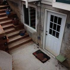 an old house with stairs leading up to the front door