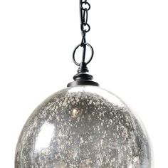 a glass ball hanging from a chain on a light fixture with white and black speckles