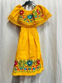 100% Authentic Mexican Dress  This Dress is gorgeous. size:10T This dress can fit up to 10 Color:Yellow  NOTE: The floral wall remain the same but the embroidery colors vary on each dress. Embroidery Mexican Dress. Boho Chic Dress Folk Fabric Flowers Mexican Tunic Traditional Embroidery This Dress is perfect for those beach day or any occasion This Dress is meant to provide extreme comfort throughout the day The perfect gift for her Yellow Embroidered Summer Dress, Yellow Summer Embroidered Dress, Fitted Yellow Dress With Floral Embroidery, Yellow Bohemian Cotton Dress, Yellow Bohemian Short Sleeve Embroidered Dress, Yellow Bohemian Embroidered Short Sleeve Dress, Yellow Bohemian Dress With Floral Embroidery, Bohemian Yellow Embroidered Dress With Short Sleeves, Yellow Embroidered Dress For Summer