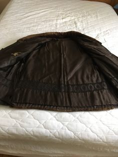 "This vintage chocolate brown sheared beaver coat is amazingly soft and snuggly warm! The chocolate brown beaver coat is accented with chocolate color leather. Easy fitting A line silhouette. Two hidden welt exterior pockets lined with velvet and one interior pocket. Fully lined with a brown satin brocade and there is an initial monogram embroidered in the fabric. Closes at the front with three fur hook. This beaver jacket will keep you toasty while on the slopes, running errands or anywhere you Vintage Brown Outerwear With Faux Fur Trim, Brown Long Coat With Faux Fur Lining, Brown Vintage Fur Coat With Faux Fur Trim, Vintage Brown Fur Coat With Pockets, Brown Fitted Long Fur Coat, Brown Long Coat With Faux Fur Trim, Fitted Brown Leather Jacket With Faux Fur Trim, Beaver Fur Coat, Vintage Chocolate