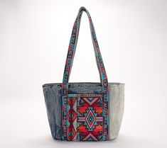 Bold and bright colored embroidery pairs with denim on the stylish Nevoso tote. With twin handles and plenty of room for storage, this bag is ready to accompany you on your travels or suit your day-to-day needs. From Patricia Nash. Blue Embroidered Canvas Bags, Embroidered Denim Bags For Everyday Use, Casual Embroidered Denim Bag, Casual Tote Shoulder Bag With Multicolor Embroidery, Casual Travel Bags With Multicolor Embroidery, Casual Multicolor Embroidered Travel Bags, Casual Multicolor Embroidery Travel Bags, Casual Shoulder Bag With Multicolor Embroidery For Everyday Use, Casual Multicolor Embroidered Shoulder Bag For Everyday Use