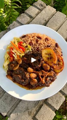 a white plate topped with rice and meat covered in sauce next to a planter