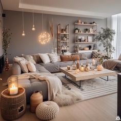 a living room filled with lots of furniture and candles on the coffee table in front of it