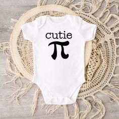 This cutie pi baby bodysuit brings out more fun on Pi Day. Crafted from 100% cotton interlock fabric, this sweet bodysuit features a reinforced three-snap closure on the binding and piped leg seams for a comfortable and snug fit. Soft and gentle on touch, it's also designed with lap shoulders for easy changing. The white color is sewn with 100% cotton thread, creating a classic heirloom look. Best of all, it's printed on a direct to garment printer with premium eco-based ink for safety and style Cute Onesie With Letter Print For Playtime, Cute Cotton Onesie For Birthday, Cotton Cute Onesie For Birthday, Cute Cotton Onesie For Playtime, Cute Letter Print Onesie For Playtime, Playful Cotton Bodysuit As A Gift, Playful Cotton Onesie For First Birthday, Unisex Cute Onesie With Letter Print, Cute Unisex Cotton Onesie