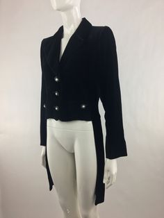 "Vintage 1990's black velvet tuxedo jacket is cropped in the front and has tails in the back; lapel; interior shoulder pads; front button closure; faux front pockets with decorative buttons; and interior lining. The condition of this item = MINT (new old stock with original tags) (Decorative button missing on the right wrist; see last pic for details. All remaining buttons are attached, but loose). BRAND: Yves Saint Laurent SIZE: 38 | Small Note: Vintage items are typically sized differently fro Black Duster, Urban Cowgirl, All Black Dresses, Evening Jackets, Cowgirl Chic, Short Kimono, Tuxedo Jacket, Black Tie, Black Velvet