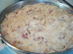 a metal pan filled with food on top of a stove