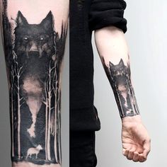 a man's arm with two wolf tattoos on it, and one is holding the other