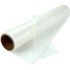 a roll of white tissue sitting on top of a piece of plastic wrapper paper