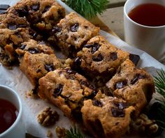 chocolate chip cookies and cups of tea on a table