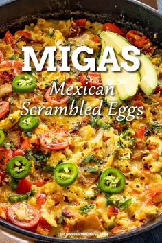 mexican scrambled eggs in a skillet with tomatoes, jalapenos and avocado