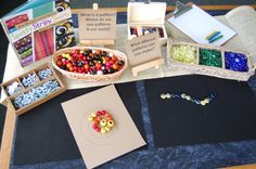 an assortment of bead supplies displayed on a table with note cards and other items