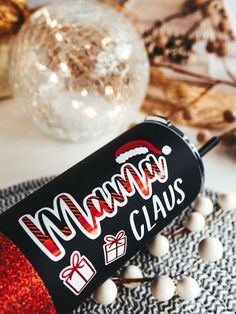 a merry claus canister sitting on top of a table next to some christmas decorations