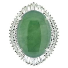 A substantial and bold ring featuring a natural 23.22 carat jadeite jade. It has an even green color and is semi-translucent allowing light to emanate from the stone. It is accented by 3.46 carats of round and baguette-cut diamonds set in a stylish pattern around the jade. Hand fabricated in platinum and ready to be worn! Ring Size 6.25 Bold Rings, Gold Cocktail Ring, Gold Cocktail, Diamond Cocktail Rings, Jade Ring, Baguette Cut Diamond, Platinum Ring, Ring Diamond, Gold Platinum