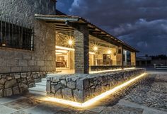 a stone building with lights on the outside