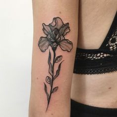 a woman's arm with a flower tattoo on the left side of her body