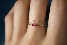 "STUNNING 14k gold filled or Sterling Silver handmade natural ruby ring set ✨ * Listing covers both the ruby ring and twisted band.  Beautiful 3mm natural ruby gemstone✨⚒️ Many cultures have long considered ruby a king's gem. Ruby symbolizes power, wealth, and protection. Many cultures have long considered ruby a stone of kings. When worn as a talisman, ruby's mystical properties extended to personal protection.  The ancient Burmese prized the ruby as the stone of soldiers. They believed it bestowed invulnerability.  Through the ages, the ruby has represented nobility, purity, and passion. The ruby is known as a protective stone that can bring happiness and passion into the life of the wearer.  The ruby is also believed to protect the wearer from negative entities that leach positive energ Dainty Stackable Ruby Jewelry, Dainty Gold Ruby Birthstone Ring, Dainty Stackable Ruby Ring For Promise, Dainty Everyday Ruby Ring, Dainty Ruby Ring With Birthstone, Dainty Ruby Birthstone Ring, Dainty Stackable Ruby Ring As Gift, Dainty Round Ruby Stackable Ring, Dainty Gold Ruby Ring With Gemstones