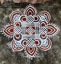 an intricate design on the ground in red and white