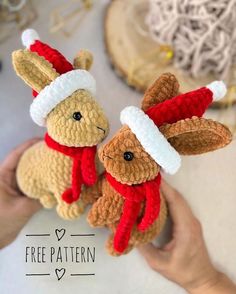 two crocheted stuffed animals wearing santa hats and holding hands in front of the camera