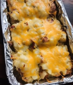 a casserole dish with cheese and meat in it on top of aluminum foil