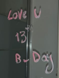 the words love u and b day written on a refrigerator door with pink spray paint