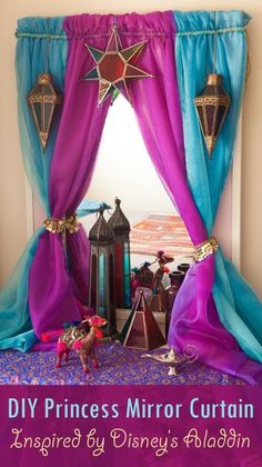 a bed with purple and blue drapes on top of it next to a window