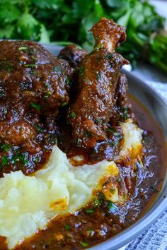 some meat and mashed potatoes on a plate