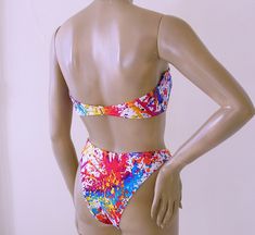 "Bandeau 2-piece bikini has hook-back strapless bandeau top: lined with standard beige swimwear lining; no pads, wires, or foam cups, with boning in sides for support. Eighties high leg Brazilian bikini bottom has minimal back coverage; lined. Nylon/spandex. Mix-and-Match Sizes! Tops available in S-M-L-XL Bottoms: S-M-L-XL. Choose your sizes for each piece from the drop-down lists. SIZING RUNS SMALL, so please read the size chart before ordering: USA SIZE CHART SMALL: Height: 5'0\"-5'4\"; Weight Fitted Triangle Tube Top For Sunbathing, Strapless Tube Top With Padded Cups For Summer, Underwire Tube Top For Summer Pool Days, Fitted Tube Top With Adjustable Straps For Pool, Summer Swimming Underwire Tube Top, Summer Tube Top With Adjustable Straps For Swimming, Underwire Tube Top For Beachwear, Underwire Tube Top For Summer Beachwear, Fitted Tube Top With Adjustable Straps For Poolside