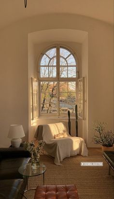 a living room filled with furniture and a large window