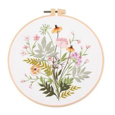 an embroidery kit with flowers and leaves on it