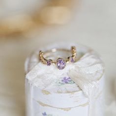 Description: Inspired by the enchanting landscapes of Provence, this delicate ring showcases a stunning amethyst gemstone set in a romantic, vintage-inspired design. The 18k gold-plated setting adds a touch of luxury and durability, making it a perfect accessory for any occasion. Product Details: -Amethyst -925 Silver base -18K Gold plated -Adjustable size Measurement: 3/4" diameter. Elegant Gold Amethyst Birthstone Ring, Elegant Amethyst Birthstone Crystal Ring, Lavender Birthstone Ring As Gift, Delicate Amethyst Ring As Gift, 14k Gold Amethyst Ring For Wedding, Elegant Purple Birthstone Ring With Open Design, Elegant Purple Birthstone Open Ring, Gold Amethyst Ring In Dainty Style, Elegant Amethyst Birthstone Open Ring