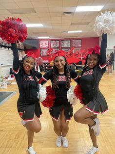 three cheerleaders are posing for the camera