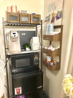 a microwave and toaster oven sitting on top of each other in a small room