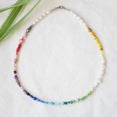 Rainbow beaded necklace is a beautiful colorful necklace with a huge selection of different kinds of beads. In this silver-plated necklace, there are genuine freshwater pearls in different shapes, sizes and colors, glass beads (seed beads, crystal glass beads, millefiori etc.), and gemstones. Each necklace is a unique piece made to order - the order and the selection of beads may vary. The length of the necklace is 16.5 inches (42 cm). Let me know if you want another length!  ♥ Jewelry care ♥ It's important to keep your jewelry dry: Take it off before taking a shower, bath, swimming, or exercising. Always apply your makeup, perfume, and hairspray before putting on your jewelry.  Store your jewelry somewhere dry (not in the bathroom). See my whole jewelry collection: https://www.etsy.com/sh Multicolor Pearl Jewelry With Pearl Chain, Silver Pearl Necklace With Colorful Beads, Colorful Pearl Beaded Choker Necklace, Bohemian Multicolor Pearl Necklace With Pearl Charm, Multicolor Bohemian Pearl Necklace With Charm, Bohemian Multicolor Pearl Necklace With Charm, Rainbow Beaded Pearl Necklace With Round Beads, Handmade Rainbow Pearl Jewelry, Colorful Beads Pearl Choker Necklace